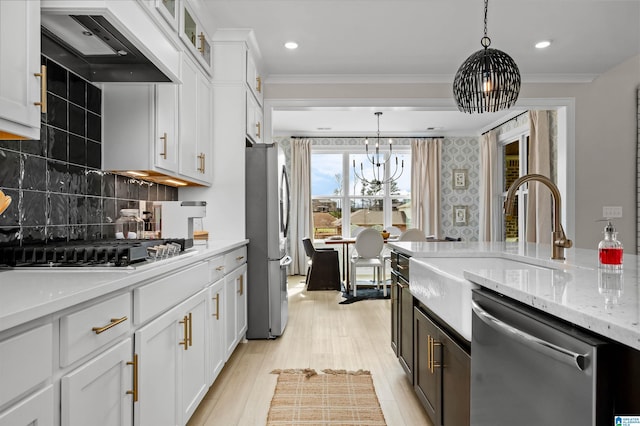 0222 Blackridge Cir, Hoover, AL 35244 - kitchen featuring stainless steel appliances, custom range hood, white cabinets, a chandelier, and ornamental molding