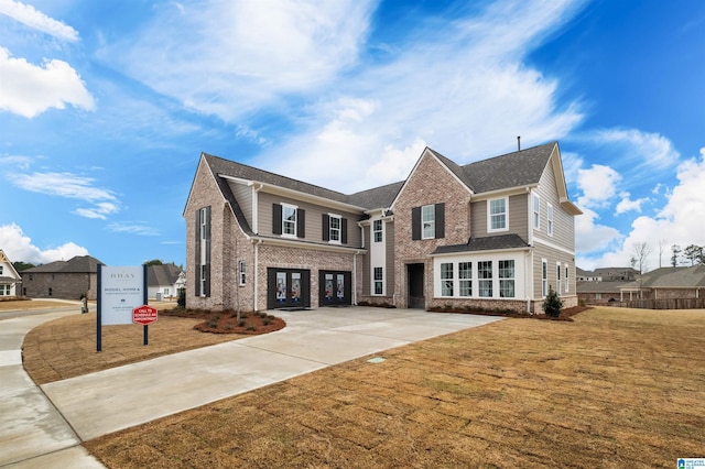 0222 Blackridge Cir, Hoover, AL 35244 - view of front of home featuring french doors, brick siding, concrete driveway, and a front lawn