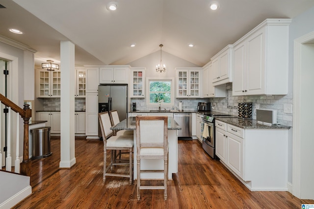 3764 Valley Head Rd, Mountain Brook, AL 35223 - kitchen with appliances with stainless steel finishes, a chandelier, a kitchen island, white cabinetry, and vaulted ceiling