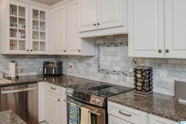 3764 Valley Head Rd, Mountain Brook, AL 35223 - kitchen with appliances with stainless steel finishes, white cabinetry, glass insert cabinets, backsplash, and dark stone countertops