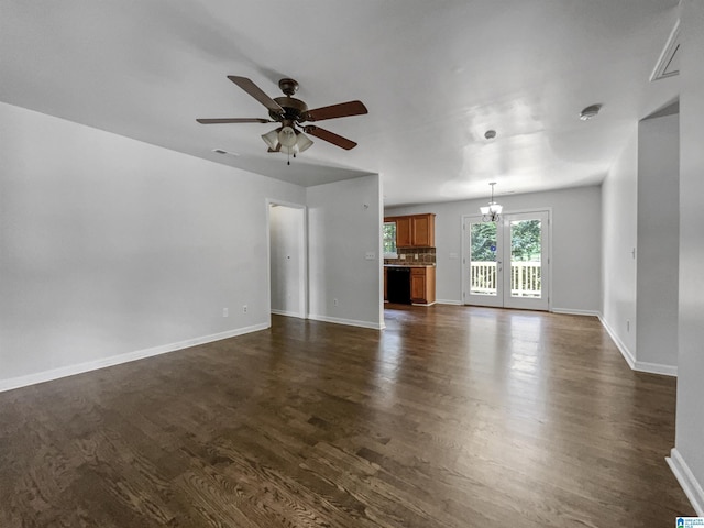 118 S Hill Dr, Wilsonville, AL 35186 - unfurnished living room featuring dark wood-style flooring, a chandelier, and a ceiling fan