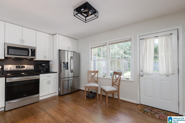 4017 Montclair Rd Unit 0, Birmingham, AL 35213 - kitchen with stainless steel appliances, dark countertops, dark wood-type flooring, and white cabinetry
