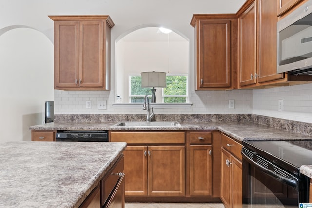 394 Glen Cross Way, Trussville, AL 35173 - kitchen featuring black appliances, decorative backsplash, and brown cabinetry