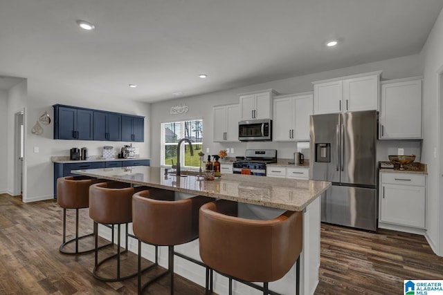 181 Halifax Ln, Chelsea, AL 35043 - kitchen with stainless steel appliances, a kitchen bar, dark wood finished floors, a kitchen island with sink, and recessed lighting