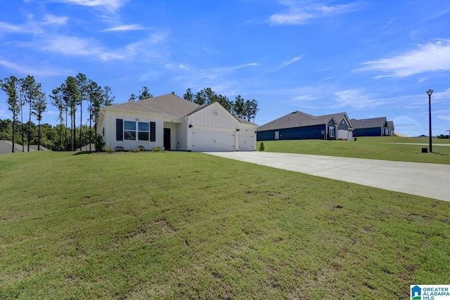 181 Halifax Ln, Chelsea, AL 35043 - view of front of property featuring board and batten siding, concrete driveway, a garage, and a front lawn