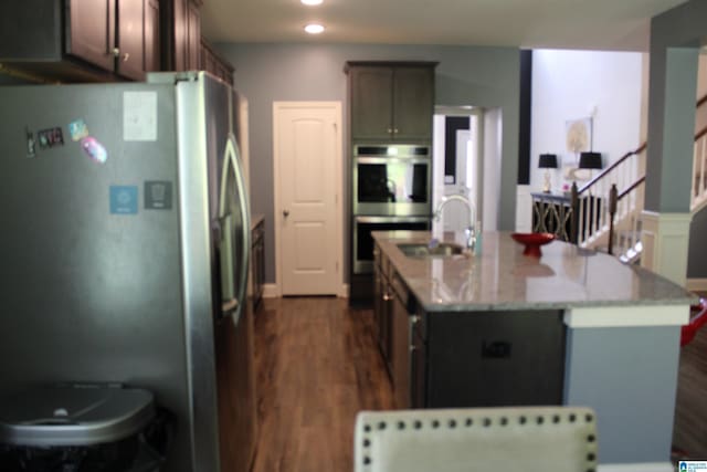 6284 Fieldbrook Cir, Mccalla, AL 35111 - kitchen with stainless steel appliances, dark wood-style flooring, a center island with sink, light stone countertops, and recessed lighting