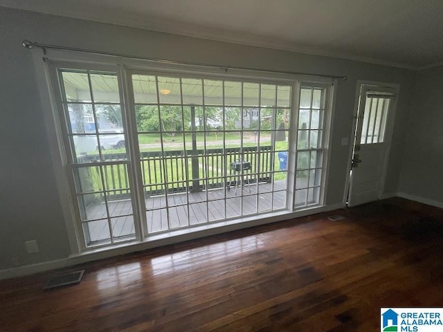 204 Gary Ave, Talladega, AL 35160 - doorway to outside with crown molding and dark wood-style flooring