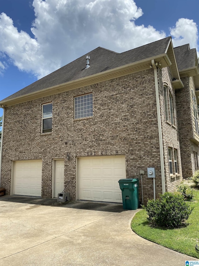 22917 Country Ridge Parkway, Mccalla, AL 35111 - view of property exterior with brick siding, an attached garage, driveway, and roof with shingles