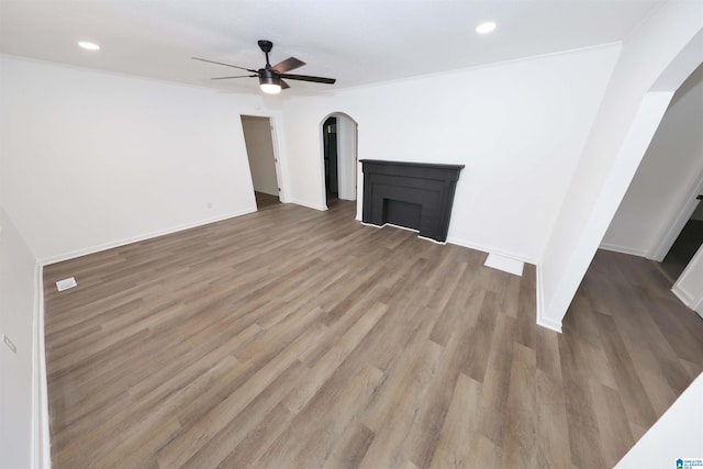 805 Jacksonville St, Weaver, AL 36277 - unfurnished living room with arched walkways, ceiling fan, wood finished floors, and recessed lighting