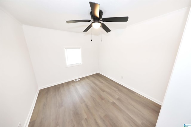 805 Jacksonville St, Weaver, AL 36277 - empty room with wood finished floors and ceiling fan