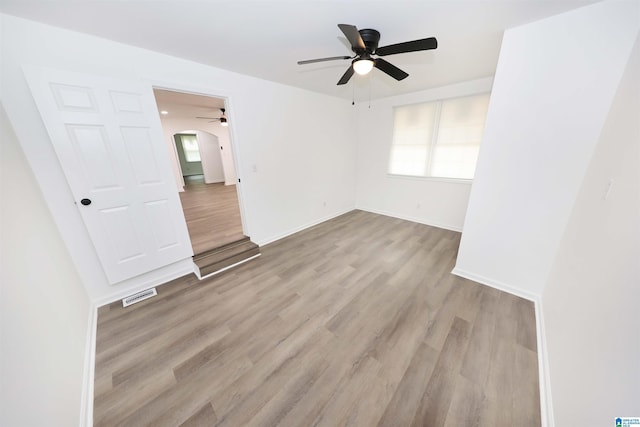 805 Jacksonville St, Weaver, AL 36277 - spare room featuring a ceiling fan, wood finished floors, and arched walkways