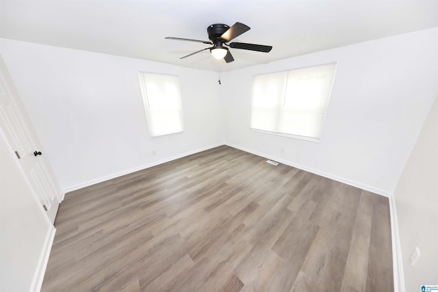 805 Jacksonville St, Weaver, AL 36277 - spare room featuring plenty of natural light, a ceiling fan, and wood finished floors
