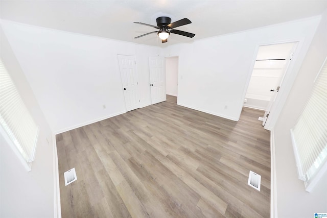 805 Jacksonville St, Weaver, AL 36277 - unfurnished bedroom with light wood-style floors, ensuite bath, and ceiling fan