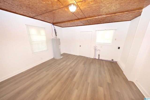 805 Jacksonville St, Weaver, AL 36277 - spare room featuring electric water heater and wood finished floors