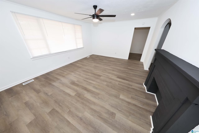 805 Jacksonville St, Weaver, AL 36277 - unfurnished living room featuring ceiling fan, wood finished floors, recessed lighting, and arched walkways