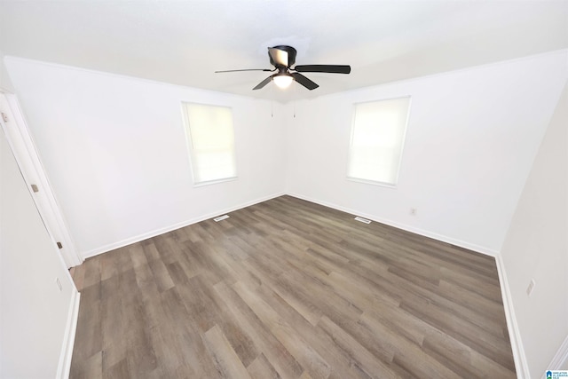 805 Jacksonville St, Weaver, AL 36277 - empty room featuring ceiling fan, wood finished floors, and plenty of natural light
