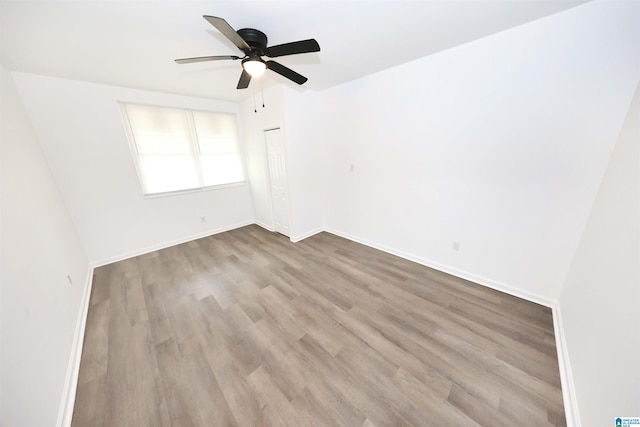805 Jacksonville St, Weaver, AL 36277 - empty room with wood finished floors and a ceiling fan