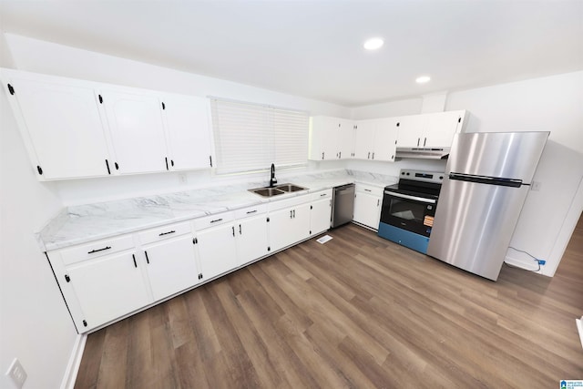 805 Jacksonville St, Weaver, AL 36277 - kitchen featuring appliances with stainless steel finishes, under cabinet range hood, white cabinetry, wood finished floors, and recessed lighting