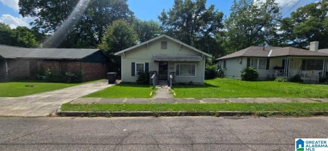 308 Oregon St, Birmingham, AL 35224 - bungalow-style home featuring a front lawn and concrete driveway
