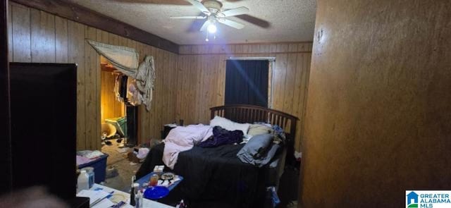 308 Oregon St, Birmingham, AL 35224 - bedroom featuring wooden walls, a textured ceiling, and a ceiling fan