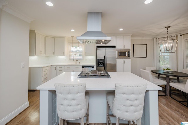 110 Pine Cliff Cir, Hoover, AL 35226 - kitchen with island range hood, appliances with stainless steel finishes, light wood-type flooring, pendant lighting, and recessed lighting