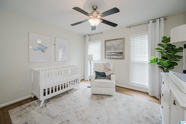 110 Pine Cliff Cir, Hoover, AL 35226 - bedroom featuring wood finished floors, a nursery area, and ceiling fan