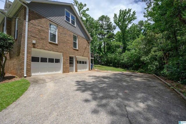 110 Pine Cliff Cir, Hoover, AL 35226 - view of home's exterior with a garage, driveway, and brick siding