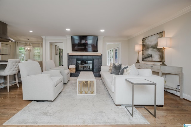 110 Pine Cliff Cir, Hoover, AL 35226 - living room featuring ornamental molding, wood finished floors, a tiled fireplace, recessed lighting, and a chandelier