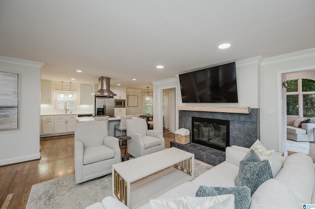 110 Pine Cliff Cir, Hoover, AL 35226 - living area with crown molding, plenty of natural light, light wood-type flooring, recessed lighting, and a fireplace