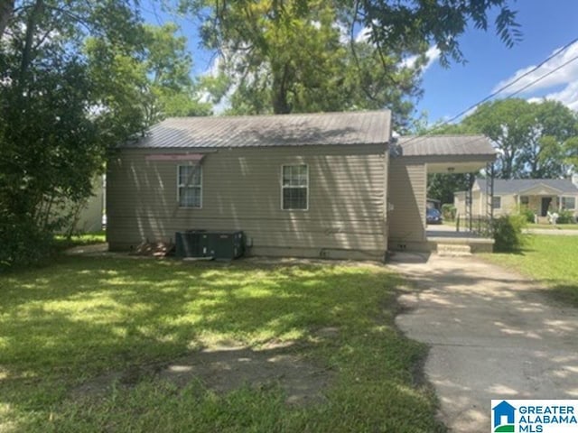 605 39th Pl, Fairfield, AL 35064 - view of side of home with a yard, an attached carport, and concrete driveway