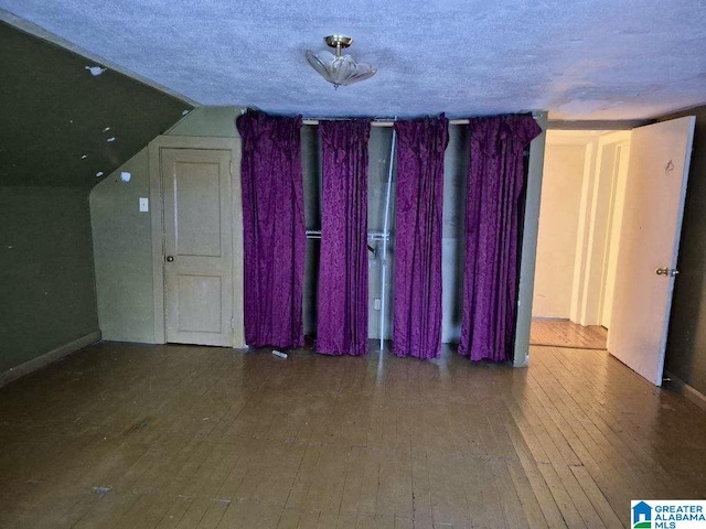 16145 US Highway 11, Springville, AL 35146 - empty room featuring hardwood / wood-style flooring, a textured ceiling, and vaulted ceiling