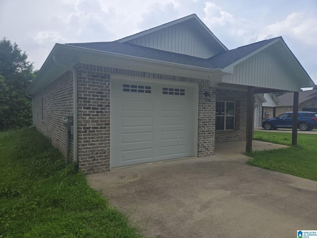107 Steppville Garden Dr, Hanceville, AL 35077 - view of home's exterior with brick siding, concrete driveway, a garage, board and batten siding, and roof with shingles