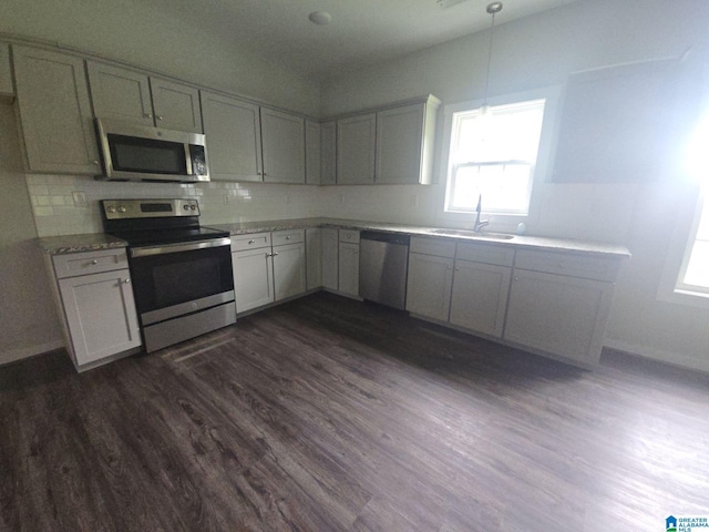 107 Steppville Garden Dr, Hanceville, AL 35077 - kitchen with stainless steel appliances, plenty of natural light, dark wood finished floors, and decorative backsplash