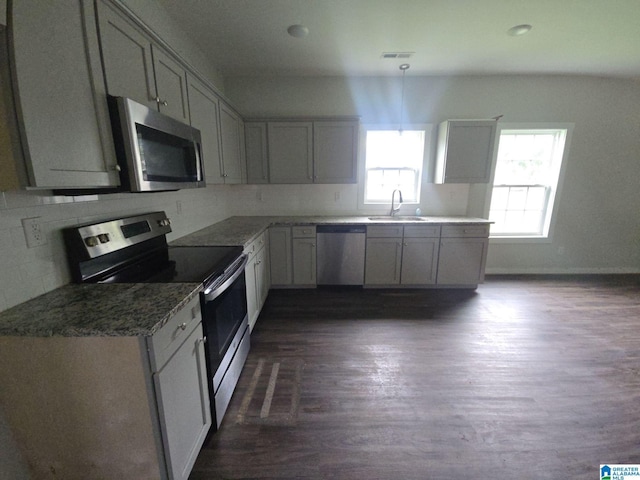 107 Steppville Garden Dr, Hanceville, AL 35077 - kitchen with stainless steel appliances, dark wood finished floors, gray cabinets, decorative backsplash, and stone countertops