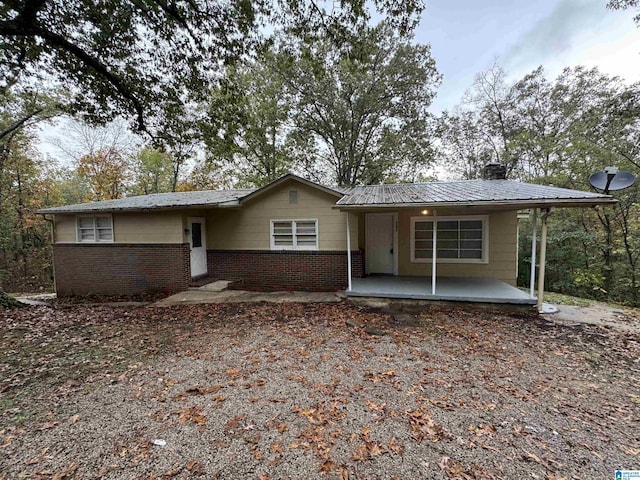 5295 Snowville Brent Rd, Dora, AL 35062 - ranch-style home with a porch, a chimney, brick siding, and a metal roof