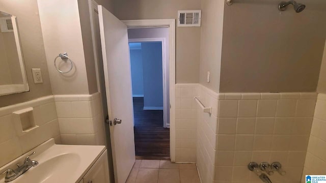 1525 Cresthill Rd, Birmingham, AL 35213 - bathroom with tile walls, tile patterned flooring, wainscoting, vanity, and a bath