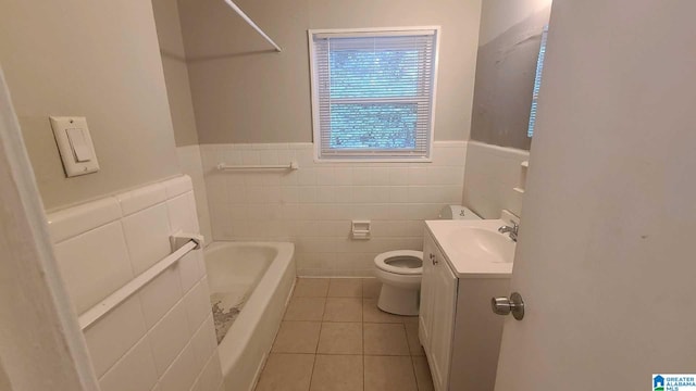 1525 Cresthill Rd, Birmingham, AL 35213 - full bathroom featuring vanity, a bath, tile patterned floors, tile walls, and a wainscoted wall