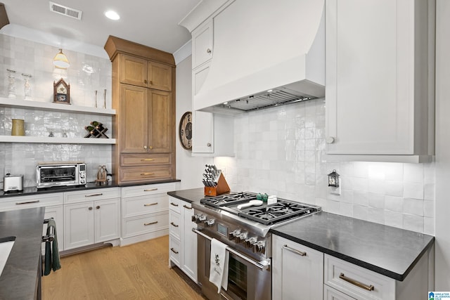 544 Preserve Way, Hoover, AL 35226 - kitchen with premium range hood, high end stainless steel range, dark countertops, tasteful backsplash, and recessed lighting