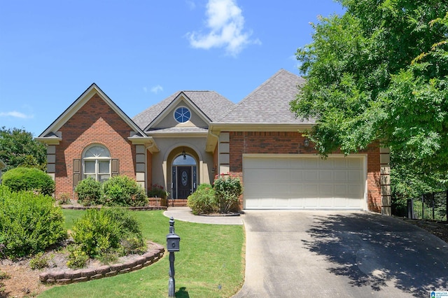 932 Cove Cir, Hoover, AL 35244 - view of front of property with concrete driveway, brick siding, a garage, and a front yard