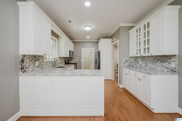 932 Cove Cir, Hoover, AL 35244 - kitchen featuring appliances with stainless steel finishes, a peninsula, decorative backsplash, glass insert cabinets, and recessed lighting