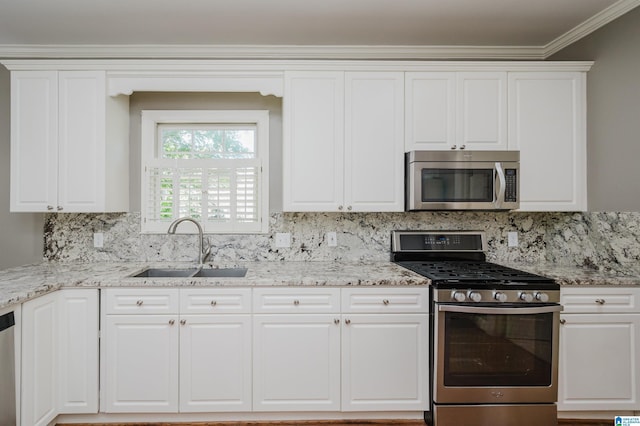 932 Cove Cir, Hoover, AL 35244 - kitchen featuring stainless steel appliances, tasteful backsplash, crown molding, white cabinetry, and light stone countertops