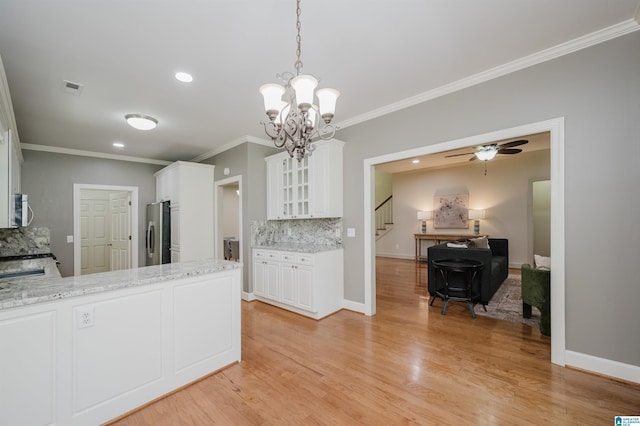 932 Cove Cir, Hoover, AL 35244 - kitchen with appliances with stainless steel finishes, ornamental molding, decorative backsplash, white cabinetry, and glass insert cabinets