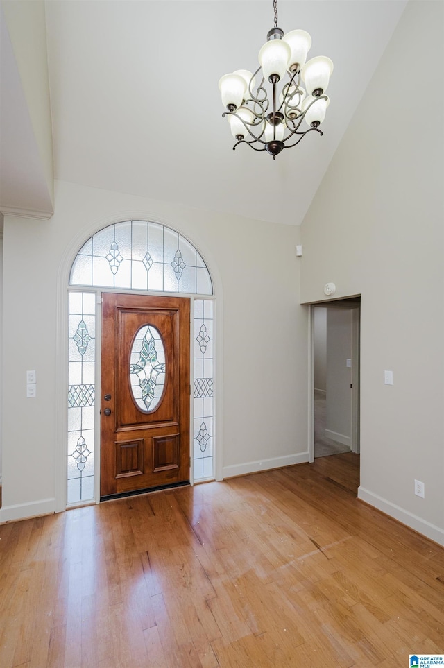 932 Cove Cir, Hoover, AL 35244 - foyer featuring a chandelier, high vaulted ceiling, and light wood-type flooring
