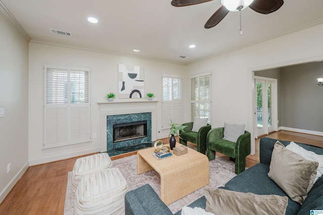 932 Cove Cir, Hoover, AL 35244 - living area featuring ornamental molding, plenty of natural light, wood finished floors, a premium fireplace, and recessed lighting