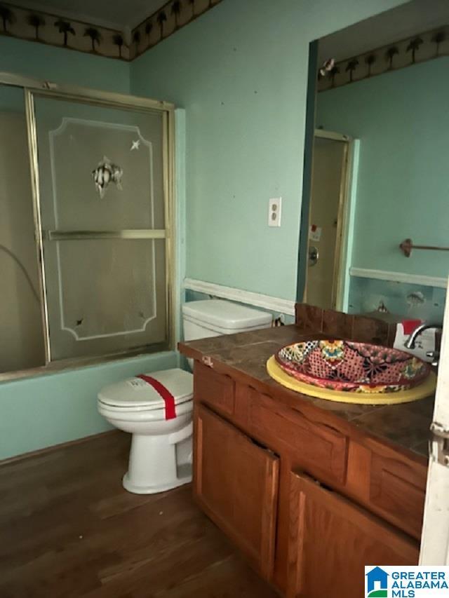 327 Canyon Ridge Rd, Sylacauga, AL 35151 - bathroom with vanity, wood finished floors, and shower / bath combination with glass door