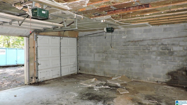 1146 Oakridge Dr, Leeds, AL 35094 - garage featuring a garage door opener and concrete block wall