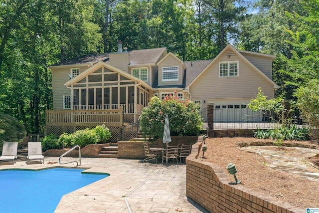 4737 Cloud Ln, Birmingham, AL 35243 - back of house featuring a sunroom, a patio, an outdoor pool, a chimney, and a shingled roof