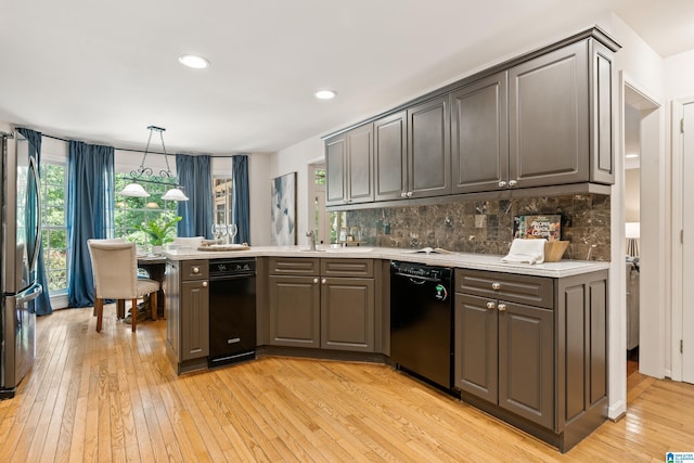 4737 Cloud Ln, Birmingham, AL 35243 - kitchen featuring dishwasher, freestanding refrigerator, a peninsula, light wood-type flooring, and light countertops