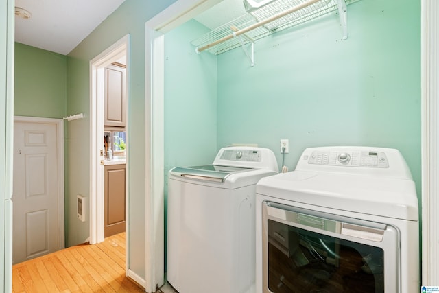 4737 Cloud Ln, Birmingham, AL 35243 - washroom with washer and clothes dryer and light wood-style flooring