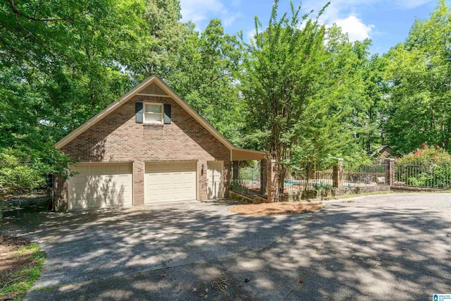 4737 Cloud Ln, Birmingham, AL 35243 - view of front facade with a garage and brick siding